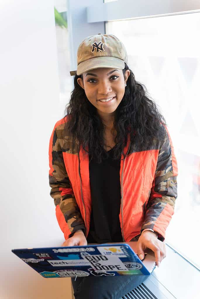 wocintech (microsoft) - 86 - 4016x6016 Young black woman with a laptop covered in stickers